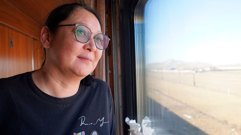 A woman looking out of a train.